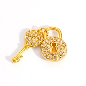 Detailed close-up of 18k gold-plated heart lock and key charms with pavé crystals