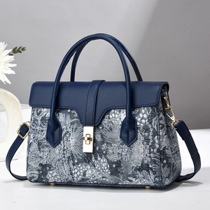 Navy blue faux leather and patterned jacquard fabric crossbody bag with gold hardware