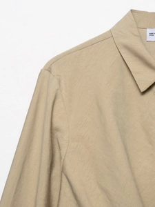 Detailed macro view showing the collar and shoulder texture of khaki twill shirt