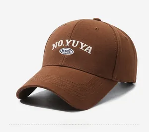 Detailed close-up of premium dark brown canvas baseball cap with white 3D embroidery