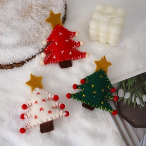 Handmade wool felt Christmas tree ornaments in red white and green for festive decoration