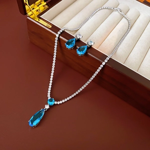 Detail of blue teardrop zircon jewelry set in premium wooden box with velvet lining