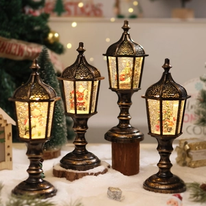 Set of four vintage bronze Christmas street lamps with warm LED lights and snow globes