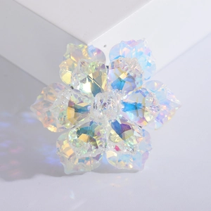 Macro detail of luxury crystal flower brooch featuring iridescent AB rainbow petals
