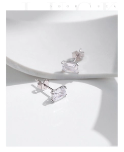 Macro shot of S925 sterling silver emerald cut stud earrings with transparent zircon