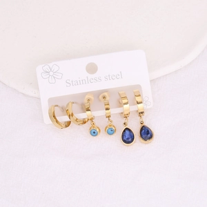 Set of three golden stainless steel earrings with evil eye and blue teardrop crystal