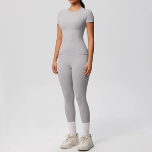 Front view of light grey slim fit short-sleeve yoga top and high-waist leggings set