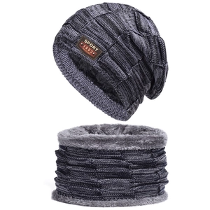 Detail of thick fleece lining and coarse knit texture on winter hat and scarf set