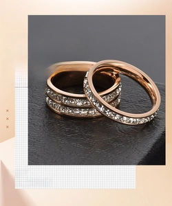 Close-up of rose gold minimalist rings featuring double-row crystal pave settings