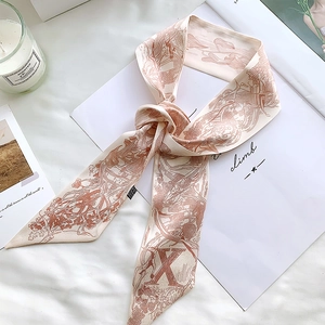 Detail of cream silk scarf with vintage brown illustrations and letter X decor