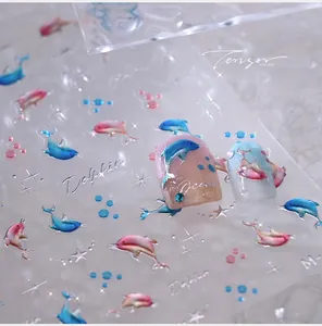 Detailed 3D embossed nail stickers featuring dolphins, stars and ocean patterns