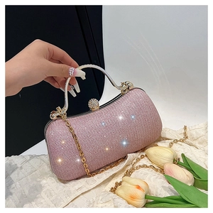 Close-up of pale pink sequined clutch bag with crystal clasp and elegant metal handle