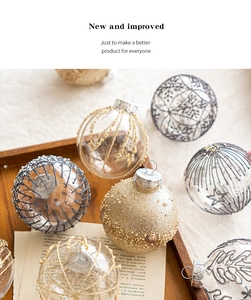 Detail of transparent Christmas ornaments with gold and silver glitter snowflake patterns