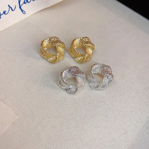 Minimalist geometric twisted stud earrings in matte gold and silver metallic finishes