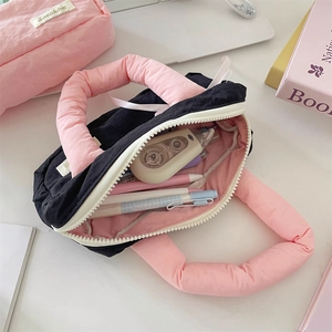 Quilted nylon stationery bag detail showing large capacity and pink contrast lining