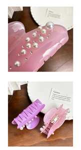 Detail of pink resin hair claw clip with inlaid white pearls and sparkling rhinestones