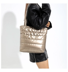 Champagne gold quilted down tote bag side view showing large capacity on model