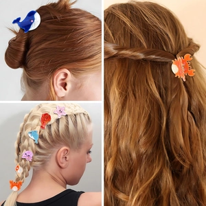 Detailed view of colorful acetate ocean animal hair claws including whale and crab shapes