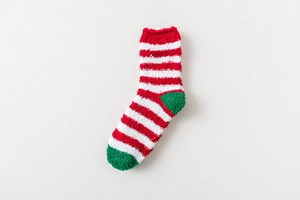 Detailed texture of fuzzy Christmas socks with red, white and green plush stripes