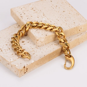 Polished gold Cuban link chain bracelet for men with large lobster clasp on stone