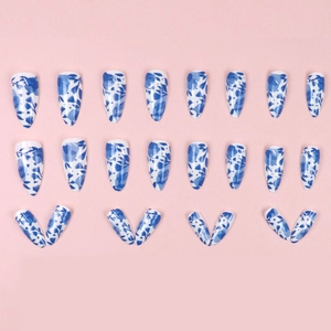 Blue floral porcelain style long almond press-on nails with white and navy leaf patterns