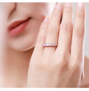 Close-up of elegant S925 sterling silver ring featuring a row of pavé pink zircon stones