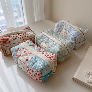 Quilted cotton makeup bags set in floral and checkered patterns with zipper closure