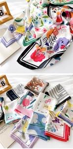 Close-up of lightweight satin square scarves with floral and abstract patterns