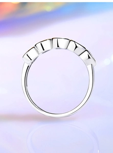 Macro view of silver stackable eternity ring with cubic zirconia inlay settings