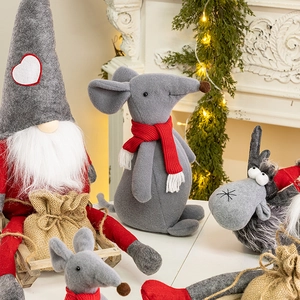 Plush Christmas gnome and mouse figurines with fabric sacks on festive background