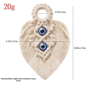 Detail showing handmade bohemian woven cotton leaf wall decor with blue evil eye beads