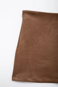 Close-up of brown suede skirt showing high-quality fabric texture and invisible zipper detail