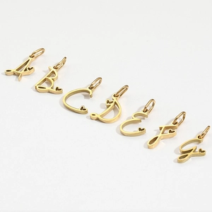 Polished gold stainless steel heart alphabet pendants with small heart charm detail