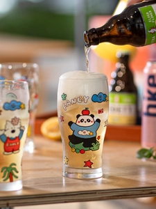 Macro detail of cartoon bear and panda glass beer mug being filled with foamy drink
