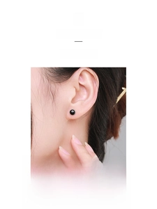 Close-up of minimalist S925 sterling silver black agate stud earrings on model's ear