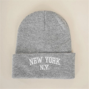 Grey knit beanie with New York embroidered letters for outdoor warmth and casual style