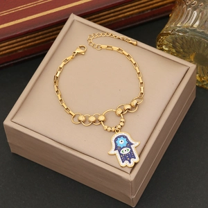 Golden stainless steel Hamsa hand and evil eye pendant necklace with blue enamel accents
