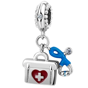 Detail of medical charm with red heart first aid kit and blue stethoscope in silver