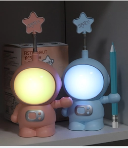 Blue and pink astronaut desk lamps with LED glowing heads and star antennae details