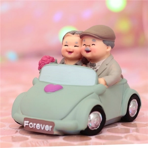 Elderly couple in a light green vintage car resin figurine with Forever license plate
