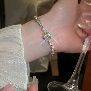 Elegant 14k gold plated bangle with zircon flower and water drop design on model