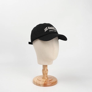 Detail of white embroidery Los Angeles Vintage Made on a black washed cotton baseball cap