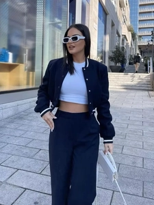 Women's chic navy baseball jacket with high-waisted wide-leg pants and crop top