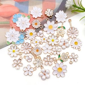 Mix of white floral charms with gold alloy edges and pearls for DIY jewelry making