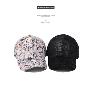 Detail view of cotton baseball caps showing white leaf print and black embossed patterns