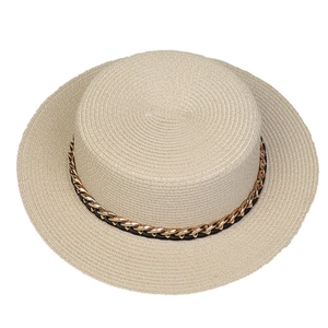 Detail of the woven texture and golden chain trim on a wide brim straw sun hat