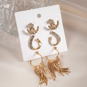 Set of gold geometric rhinestone C-shape and long tassel earrings on white display card