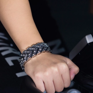 Men's punk titanium steel bracelet with micro skull embossed chevron links on wrist