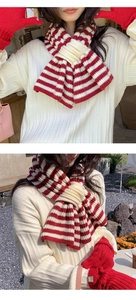 Detailed knit texture of red and white striped wool scarf with matching knitted gloves