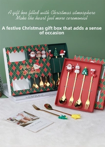 Close-up of golden stainless steel spoons and forks with festive silicone cartoon charms